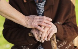 caring hands on cane